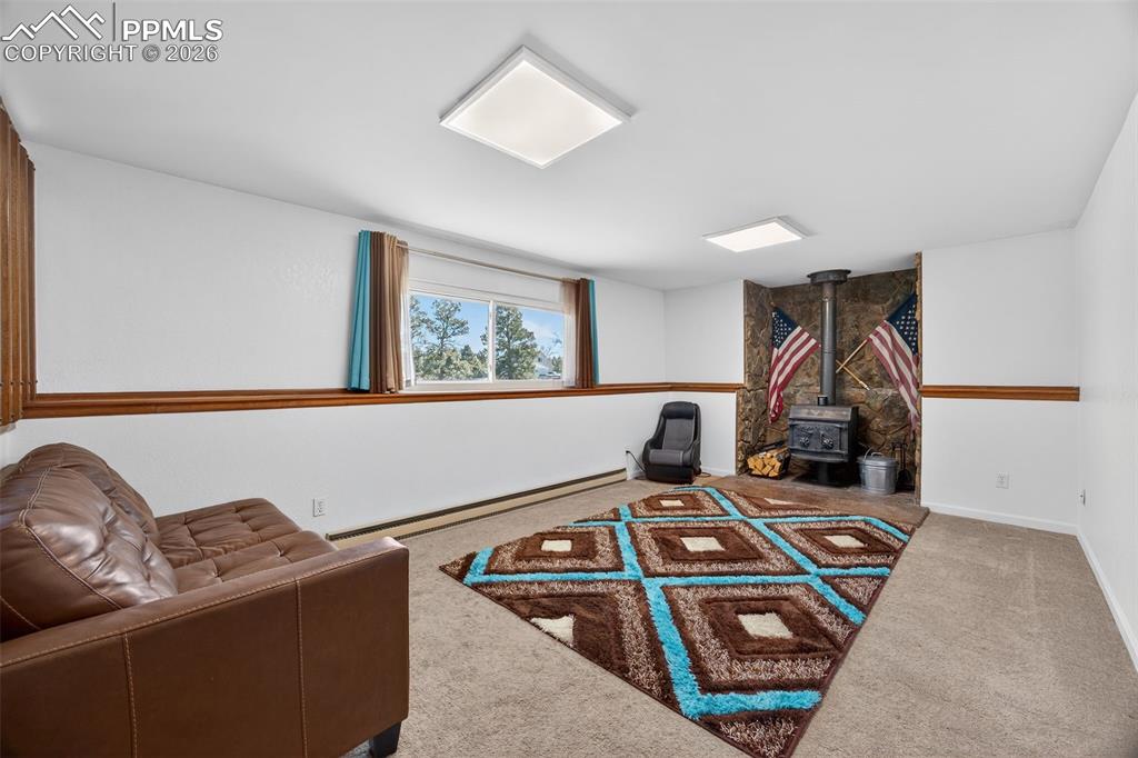 Image 17 of 34: Lower Family Room with Wood-burning Stove
