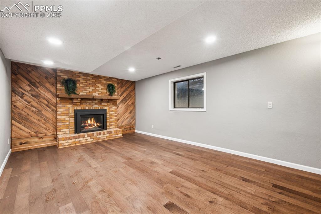 Image 35 of 42: Large basement room. Could be a bedroom as it has 4 walls and a door.