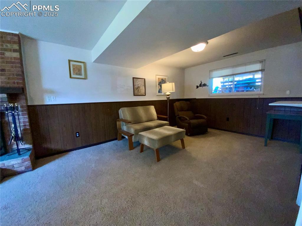 Image 18 of 22: Lower Level Family Room with Wood Burning Fireplace
