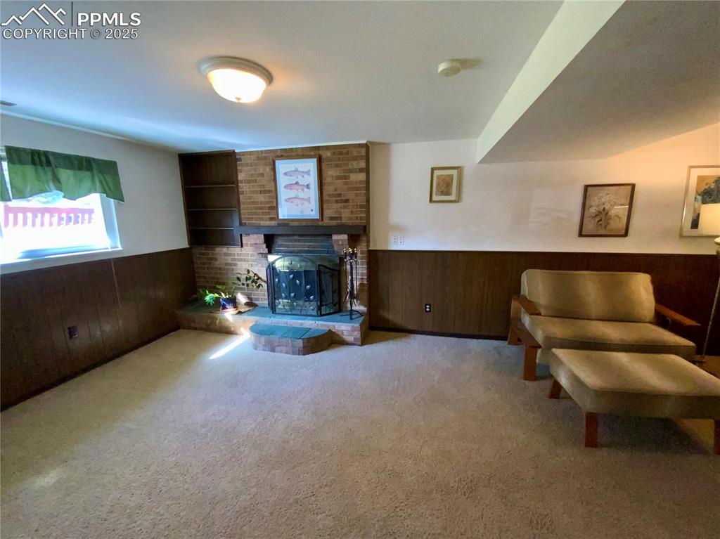 Image 19 of 22: Lower Level Family Room with Wood Burning Fireplace
