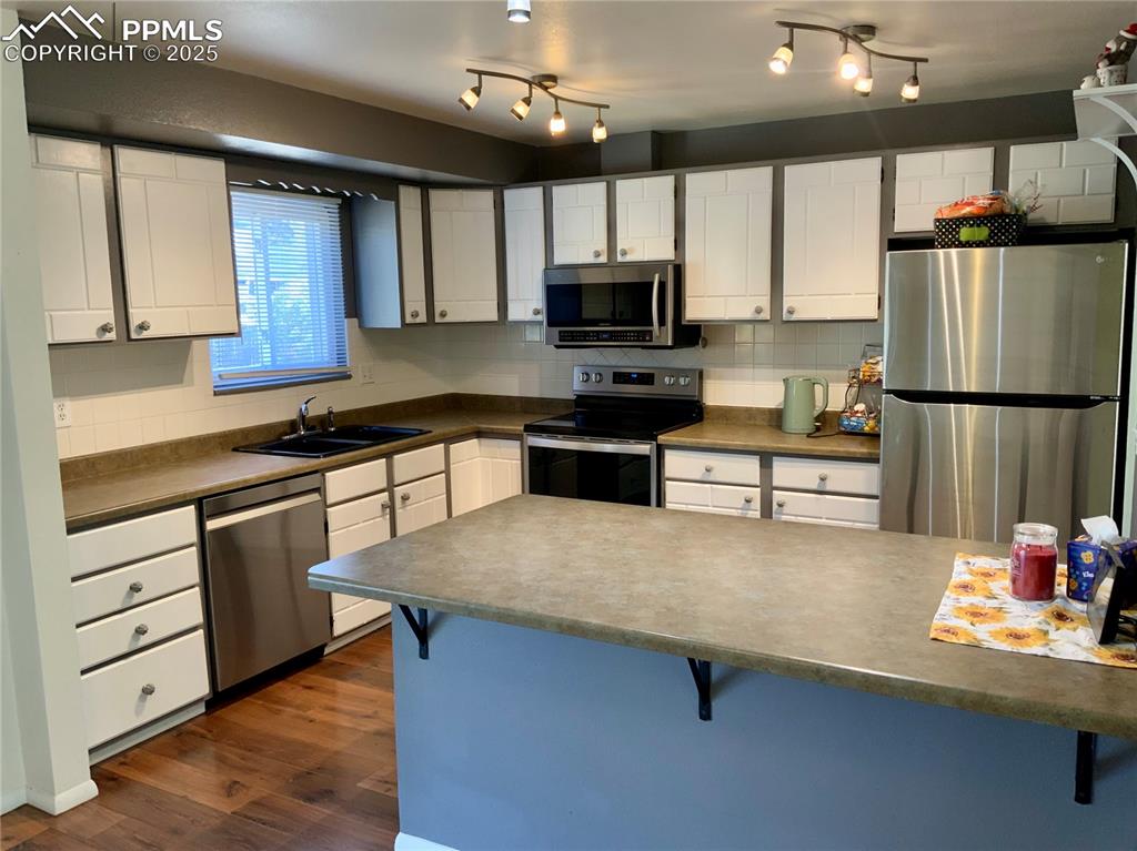 Image 6 of 22: View of Kitchen with Solid Countertops & Stainless Steel Appliances