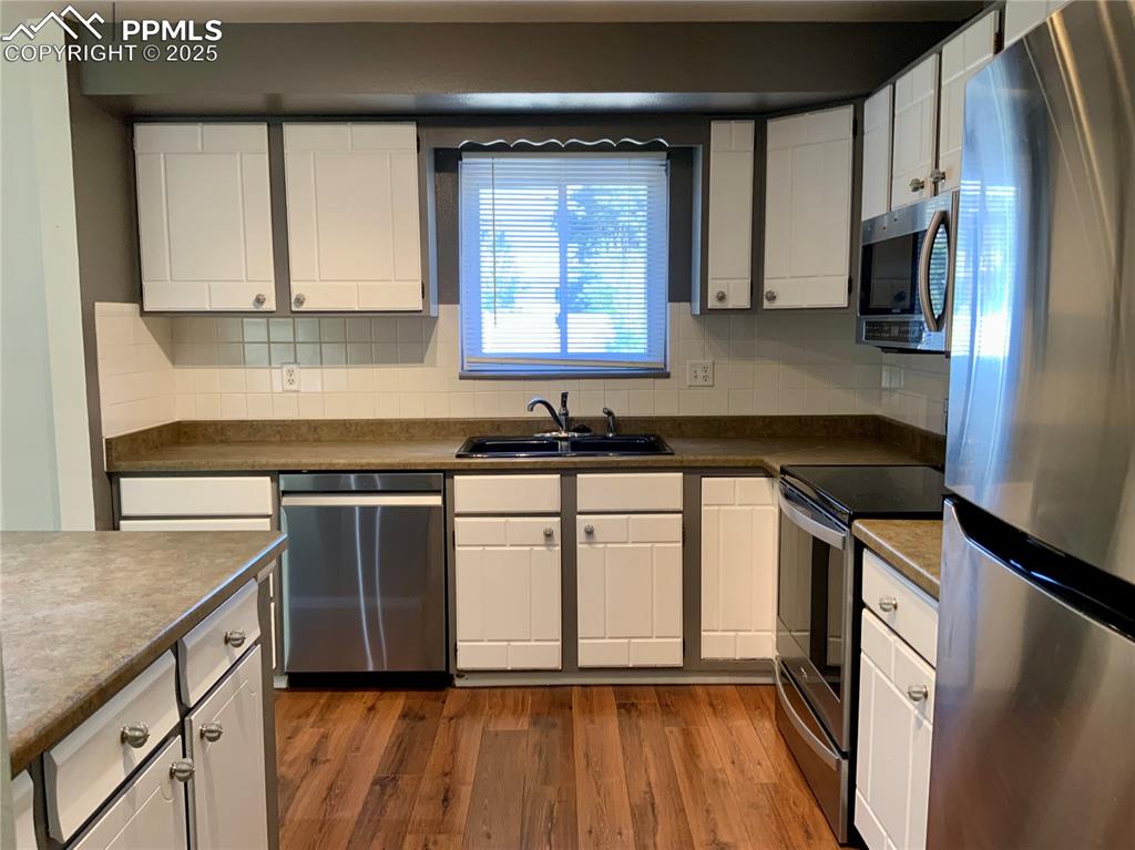 Image 7 of 22: View of Kitchen with Solid Countertops & Stainless Steel Appliances