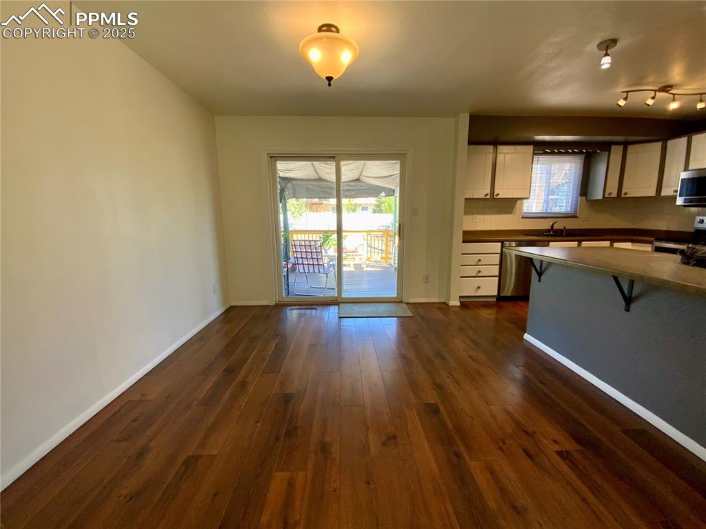 Image 9 of 22: Dining Area with Wood Laminate Floors