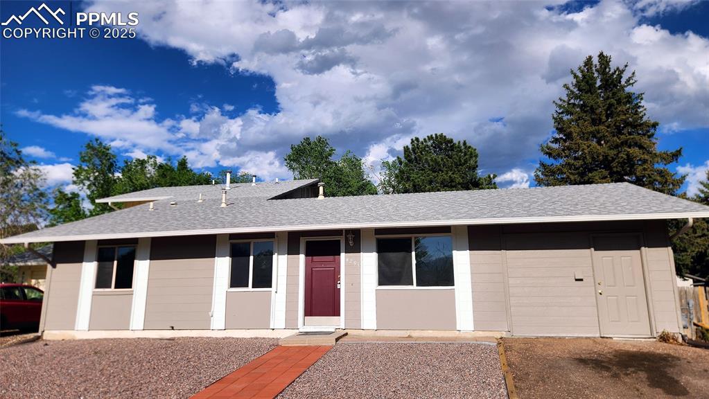 Caption: View of front of house featuring a shingled roof
