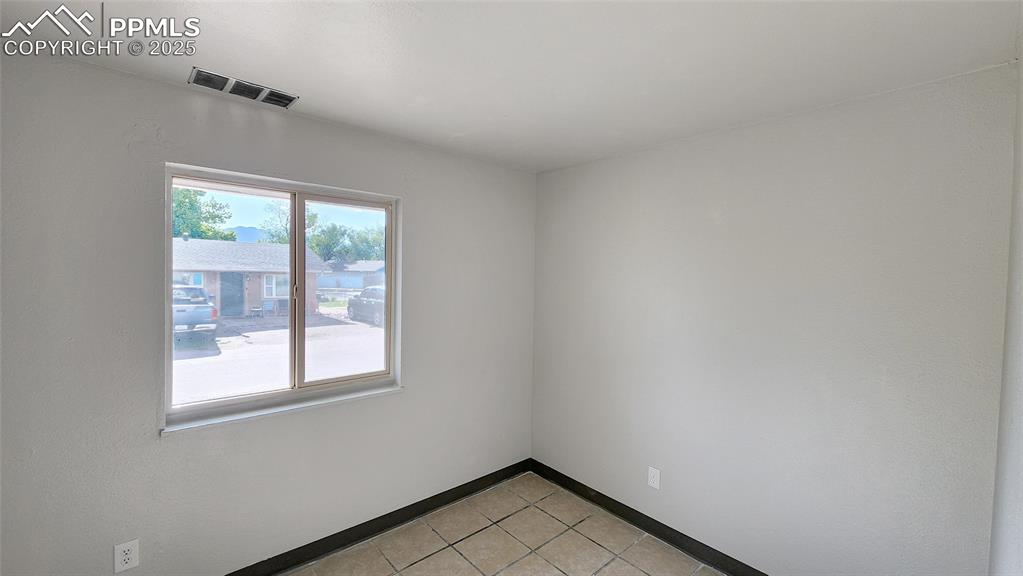 Image 10 of 15: Unfurnished room featuring light tile patterned floors and baseboards
