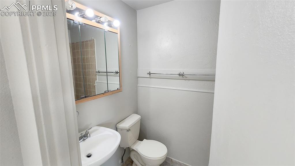 Image 13 of 15: Bathroom with a sink and toilet
