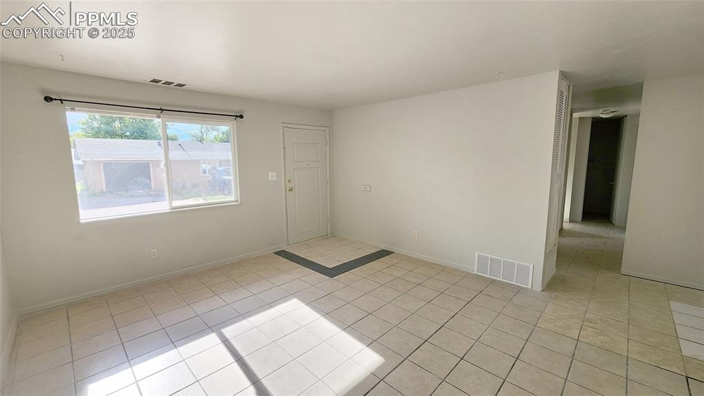 Image 3 of 15: Unfurnished room with light tile patterned floors and baseboards
