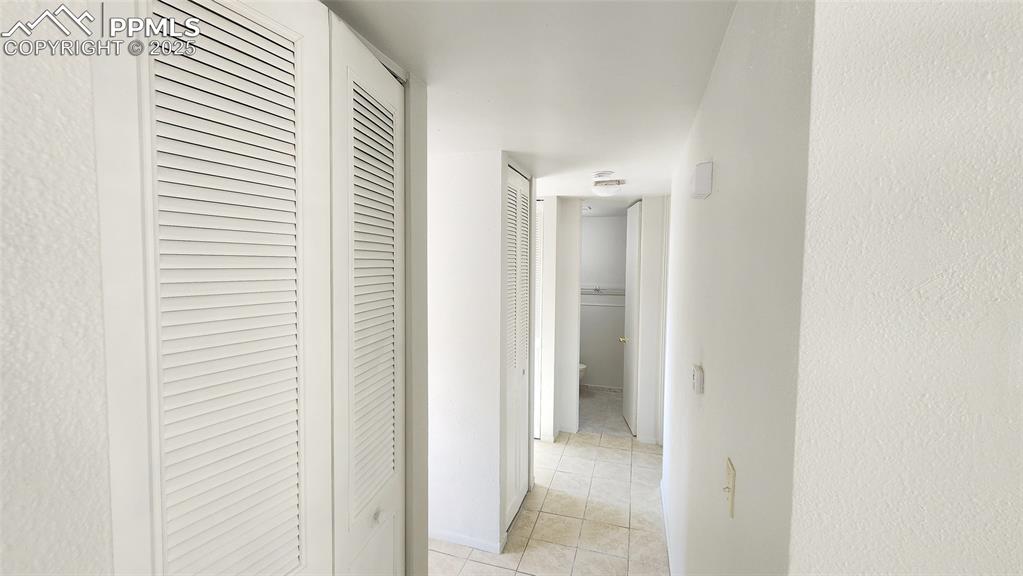 Image 7 of 15: Hallway with light tile patterned floors