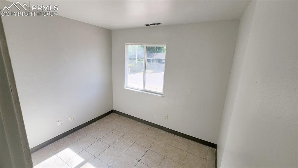Image 8 of 15: Unfurnished room featuring baseboards and light tile patterned floors