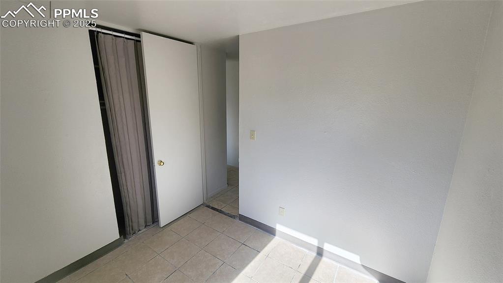Image 9 of 15: Unfurnished bedroom featuring light tile patterned floors
