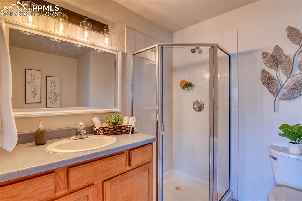 Image 19 of 46: Bathroom featuring vanity and a shower stall