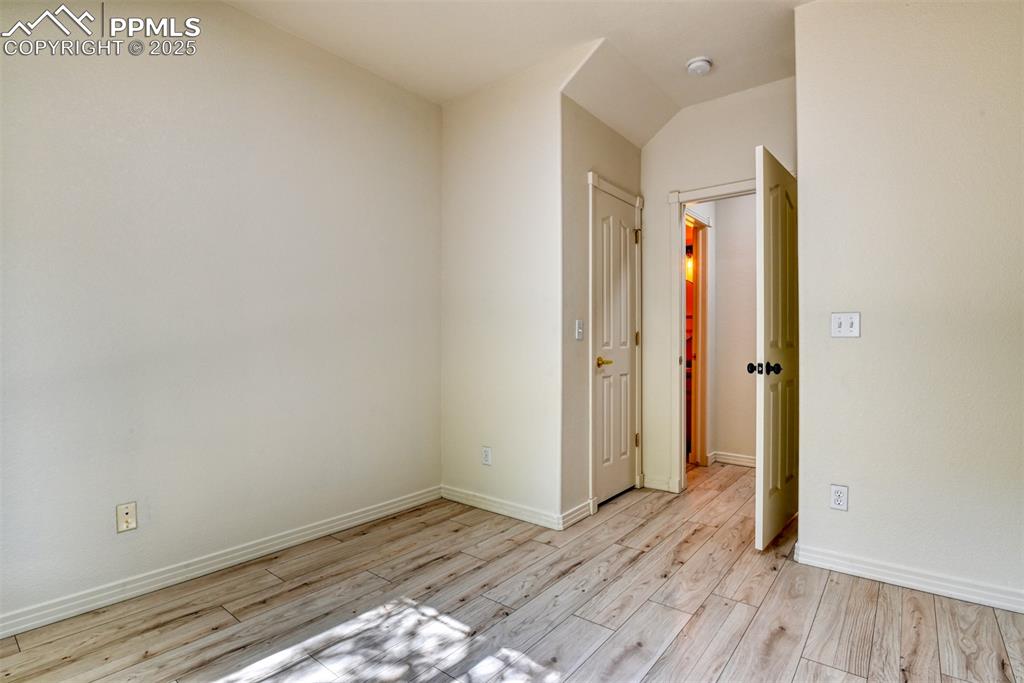Image 23 of 46: Empty room with baseboards and light wood-style flooring