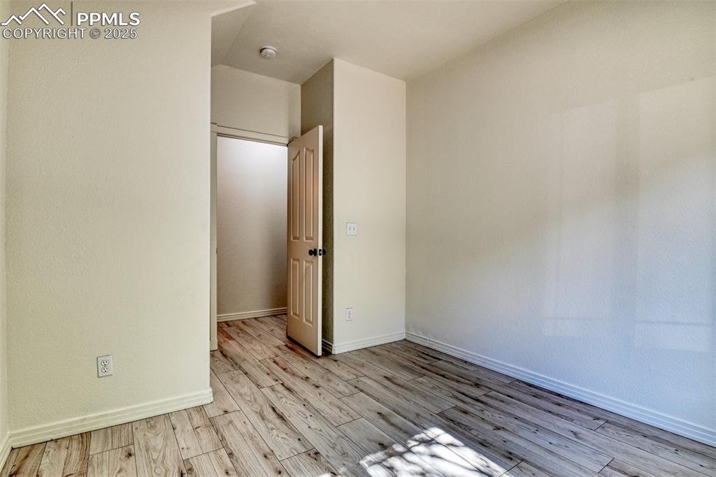 Image 24 of 46: Spare room featuring baseboards and light wood-style flooring