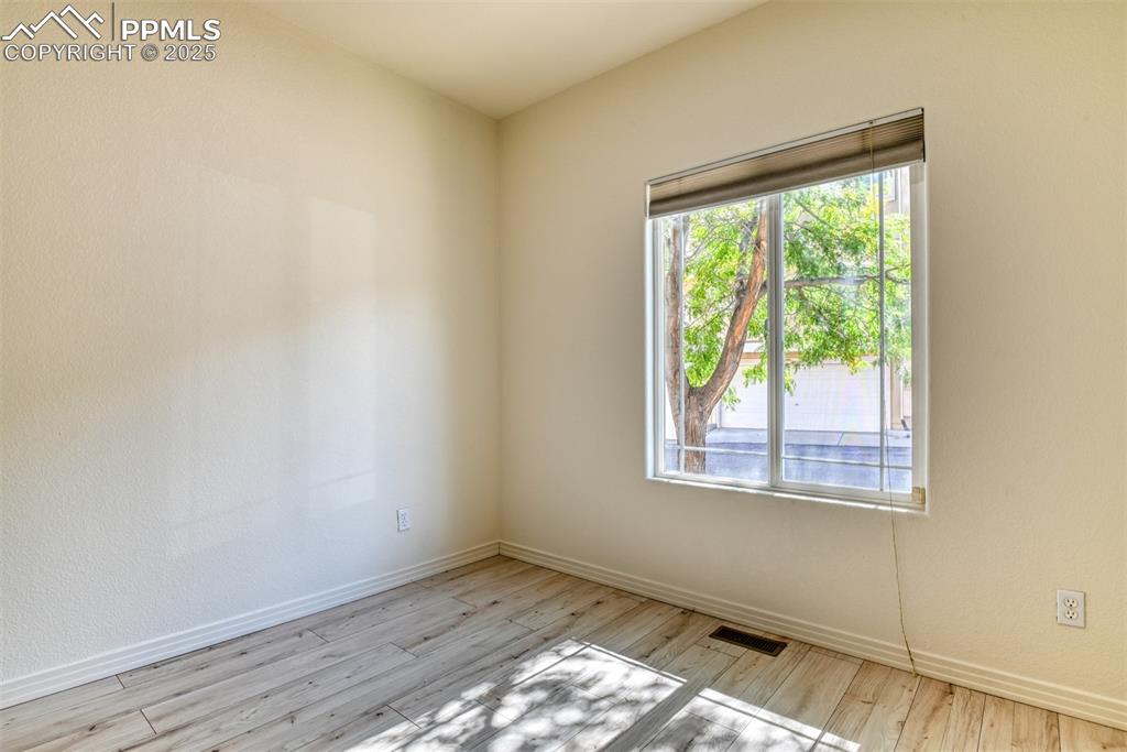 Image 25 of 46: Spare room featuring baseboards and light wood-style floors