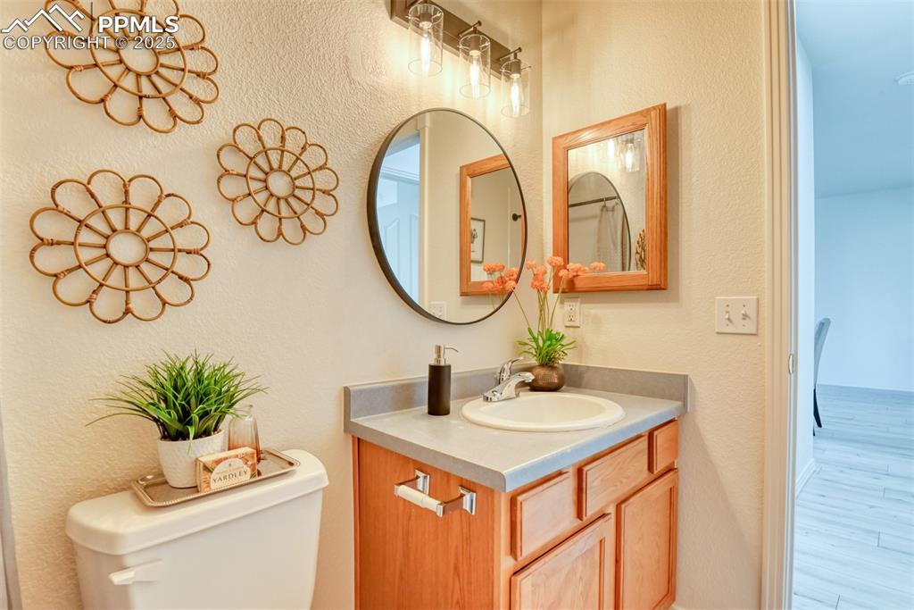 Image 27 of 46: Bathroom featuring a textured wall and vanity