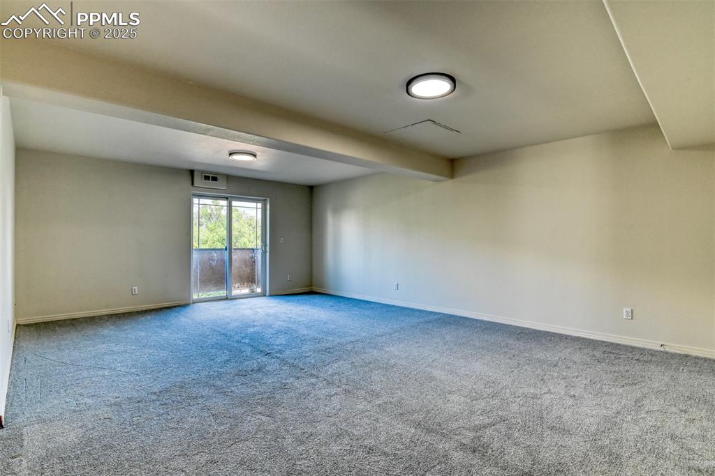 Image 30 of 46: Empty room featuring carpet and baseboards