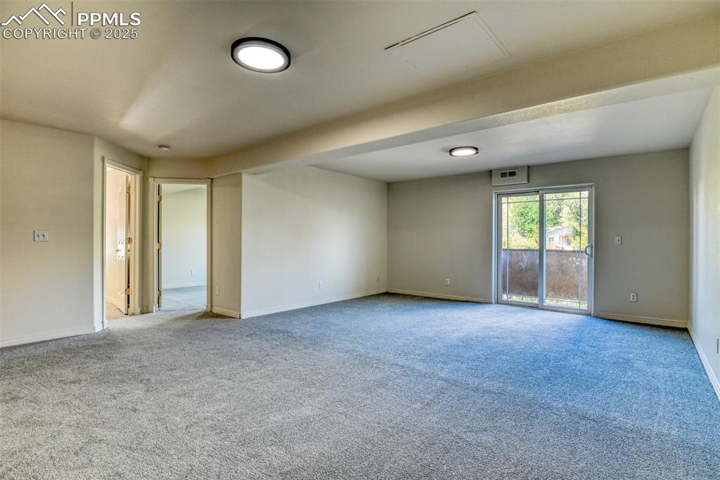 Image 31 of 46: Carpeted empty room with baseboards
