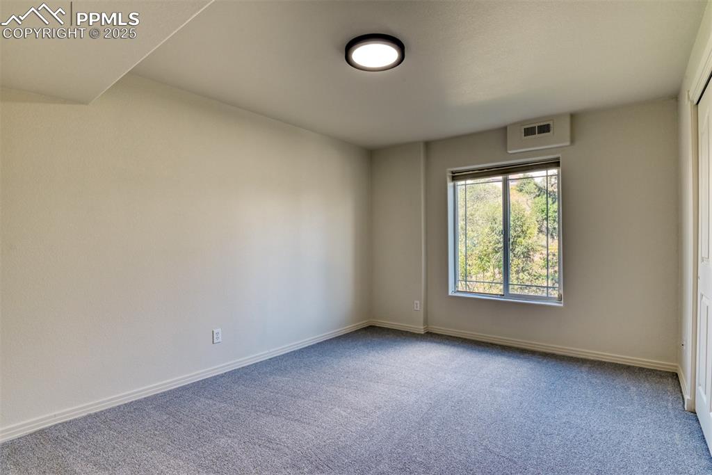 Image 34 of 46: Unfurnished room with carpet floors and baseboards