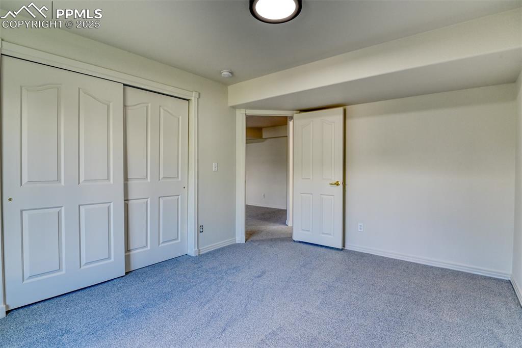 Image 36 of 46: Unfurnished bedroom with carpet flooring and a closet