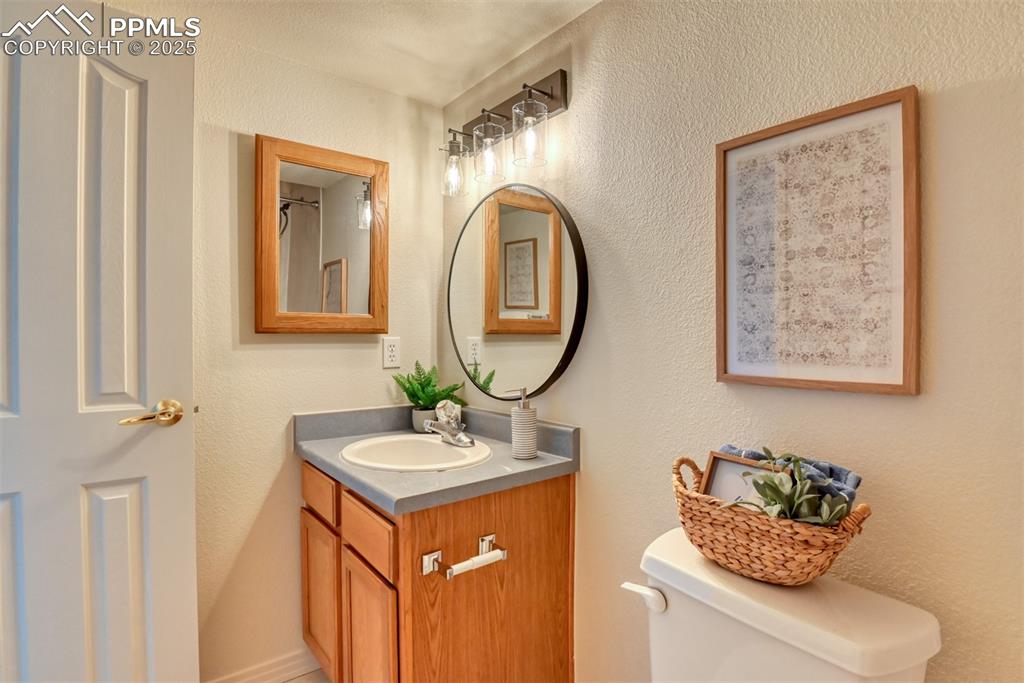 Image 39 of 46: Full bath featuring a textured wall and vanity