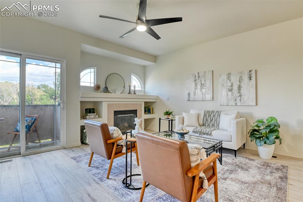 Image 4 of 46: Living room with light wood finished floors, plenty of natural light, a fir