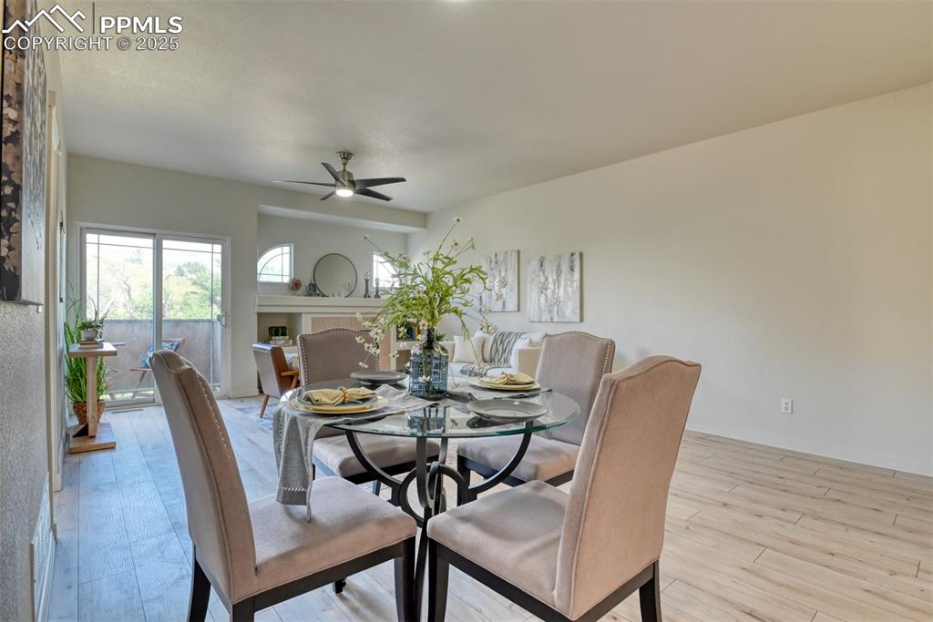 Image 6 of 46: Dining space with light wood-style flooring and ceiling fan