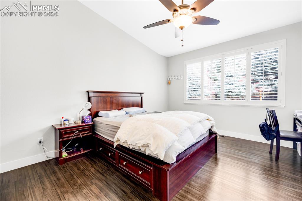 Image 16 of 37: Bedroom featuring dark wood-type flooring, vaulted ceiling, and ceiling fan
