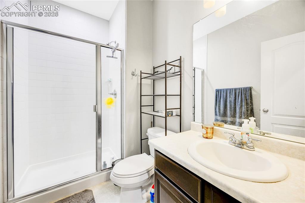 Image 23 of 37: Bathroom with vanity and a stall shower