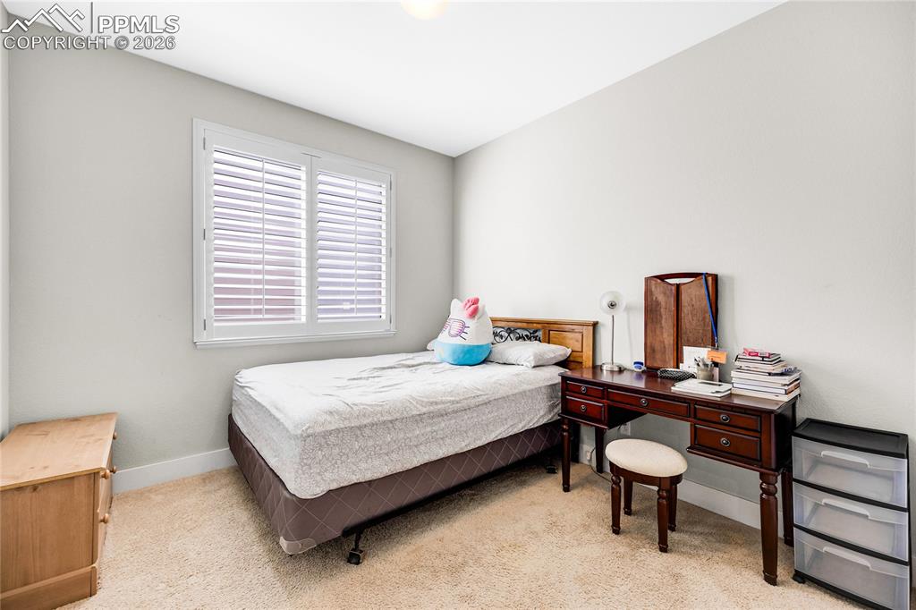 Image 28 of 37: Bedroom with light colored carpet and baseboards