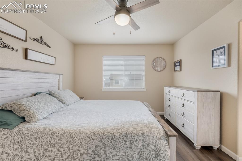 Image 11 of 35: The main level primary suite offers luxury planking floors and a 5 piece en