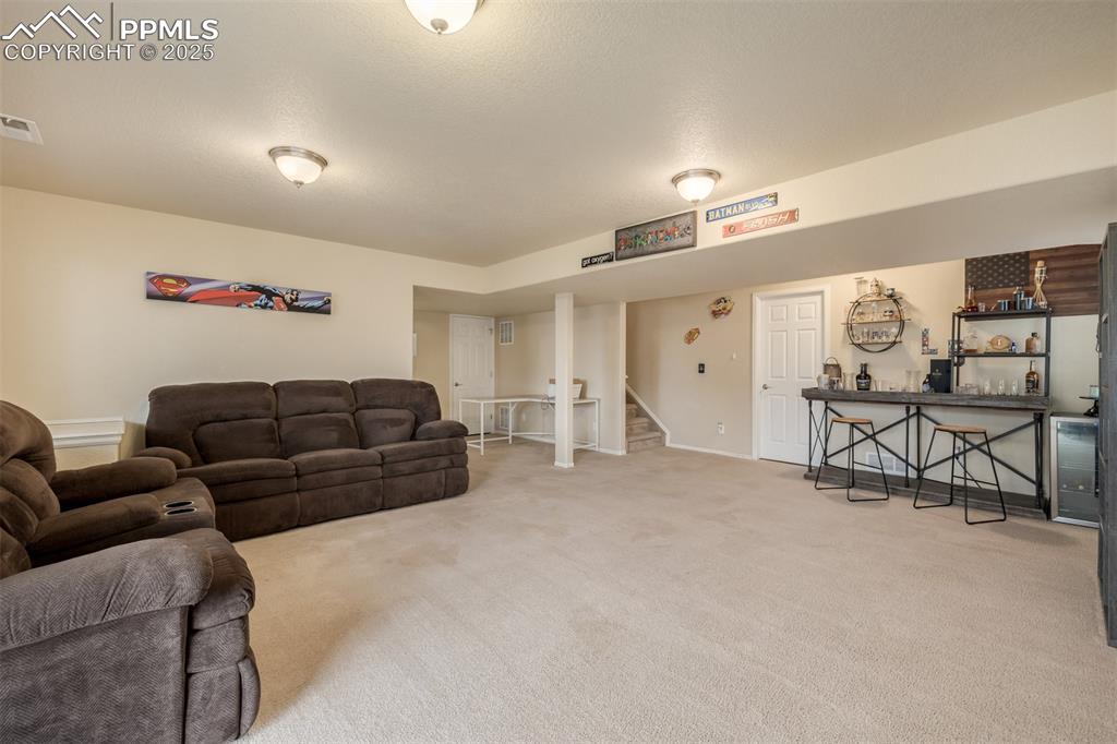 Image 22 of 35: This spacious basement also offers an office or gym space