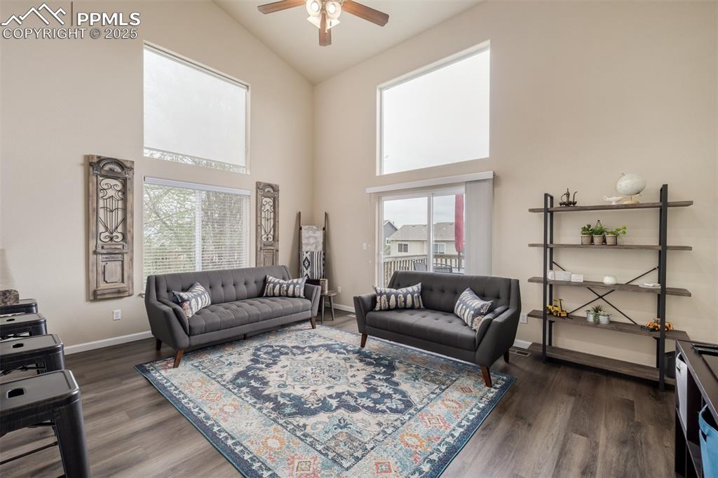 Image 5 of 35: The living room features vaulted ceilings, picture windows to capture the m
