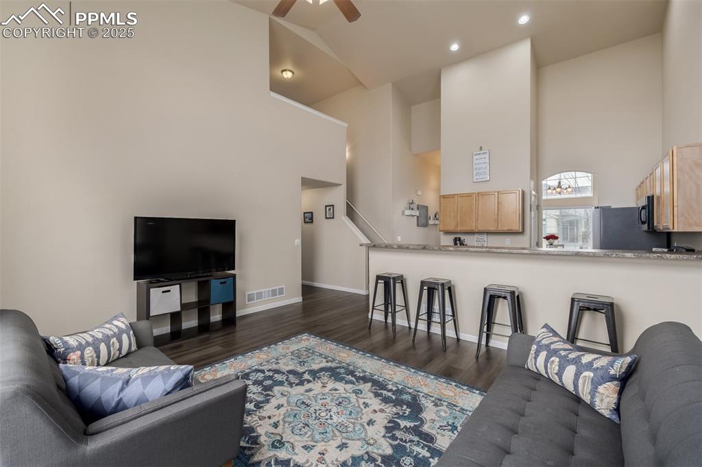 Image 6 of 35: Open to the kitchen and main living space, this living space is sure to ple