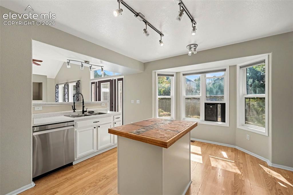 Image 12 of 31: White cabinetry and stainless steel appliances