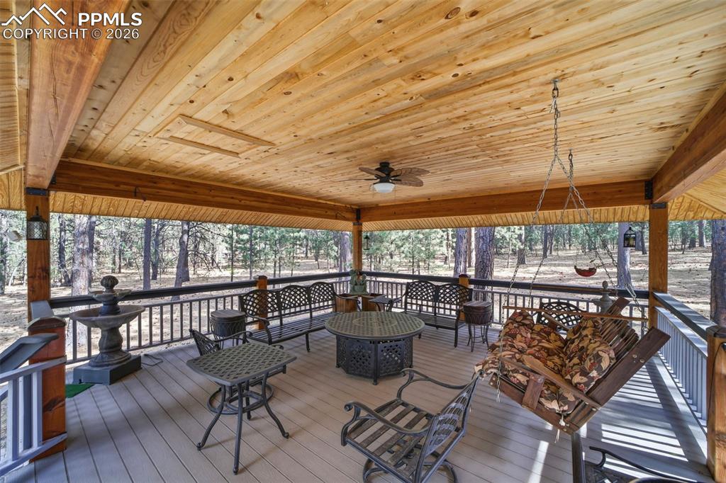 Image 10 of 50: Large covered second deck with a ceiling fan