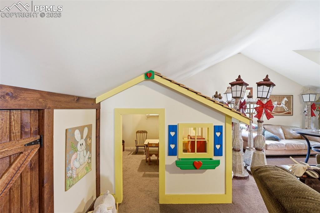 Image 16 of 50: Playroom at bonus loft above detached garage