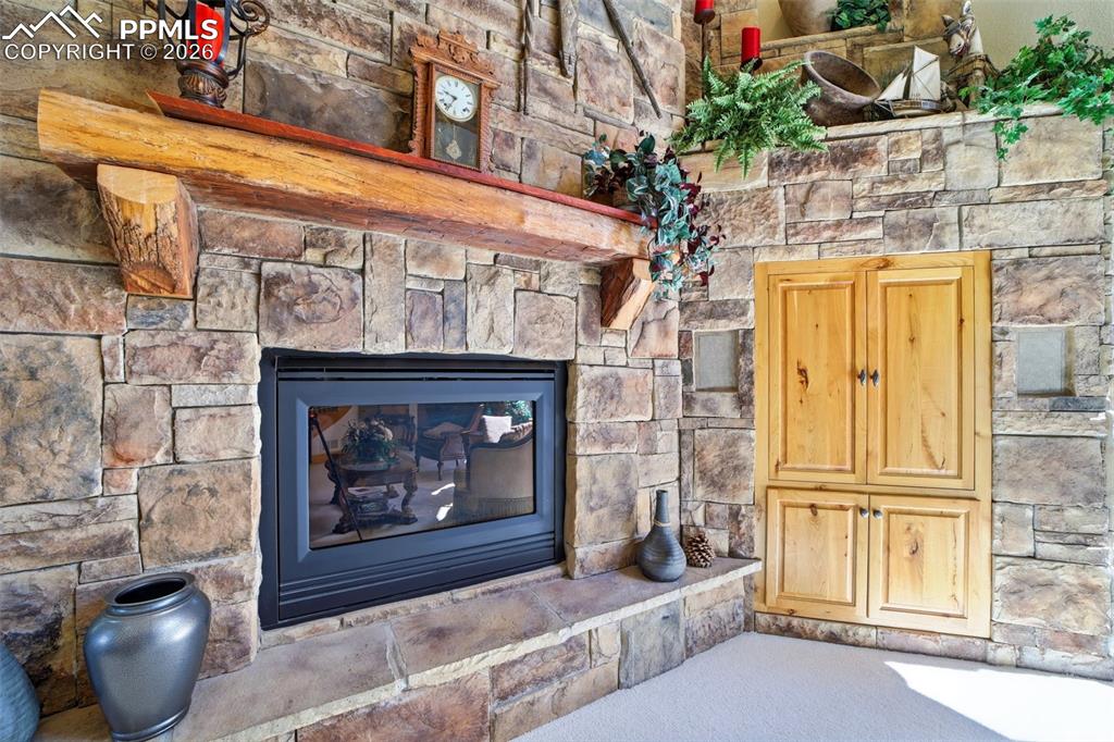 Image 20 of 50: Focal point of living room with built in wood entertainment cabinets and ma