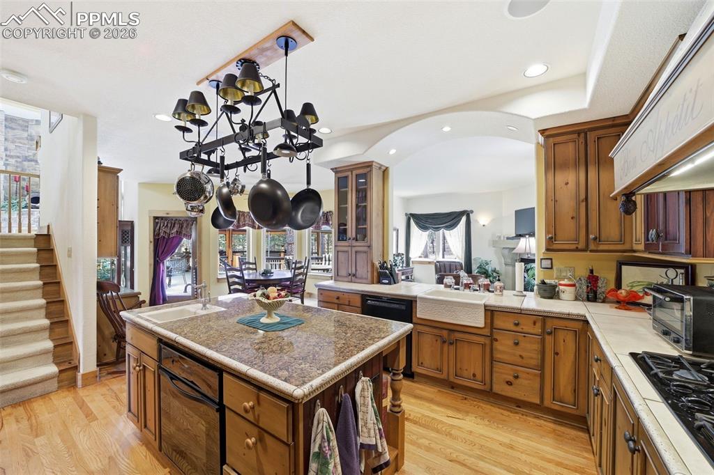 Image 24 of 50: Large open kitchen with chef island prep sink and full cooking  sink, wood 