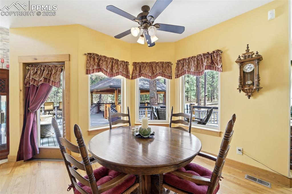 Image 26 of 50: Informal kitchen Dining space featuring a ceiling fan and light wood finish