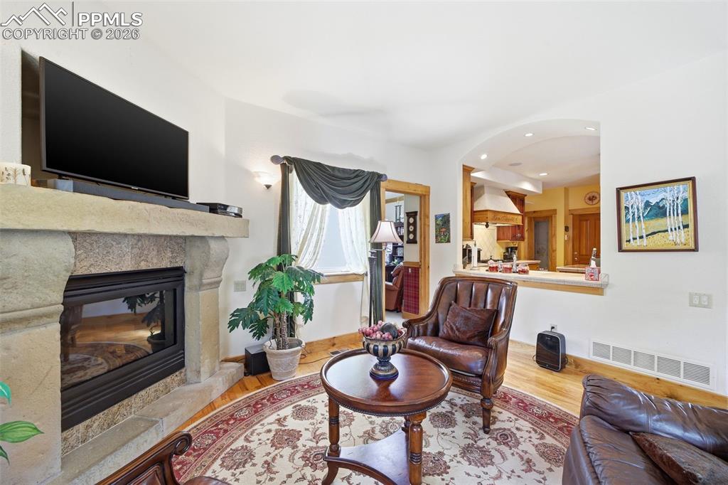 Image 28 of 50: Conversation speak easy nook near kitchen with cozy fireplace