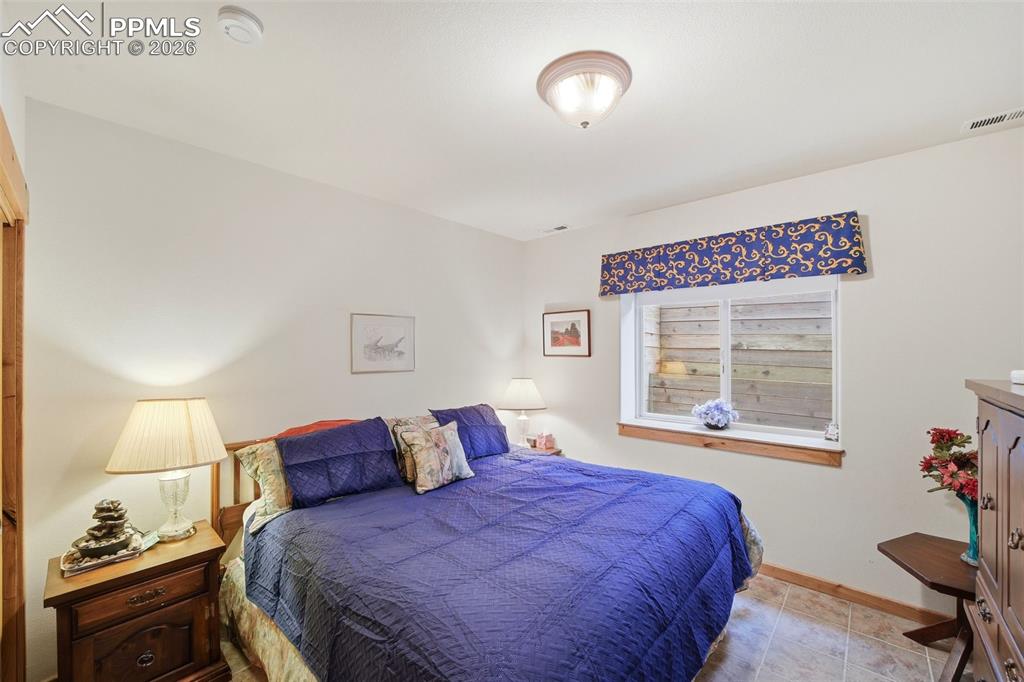 Image 36 of 50: Bedroom featuring baseboards