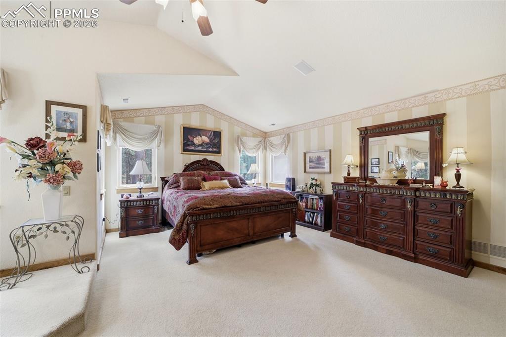 Image 38 of 50: Primary Bedroom featuring lofted ceiling, ceiling fan, views, private sitti