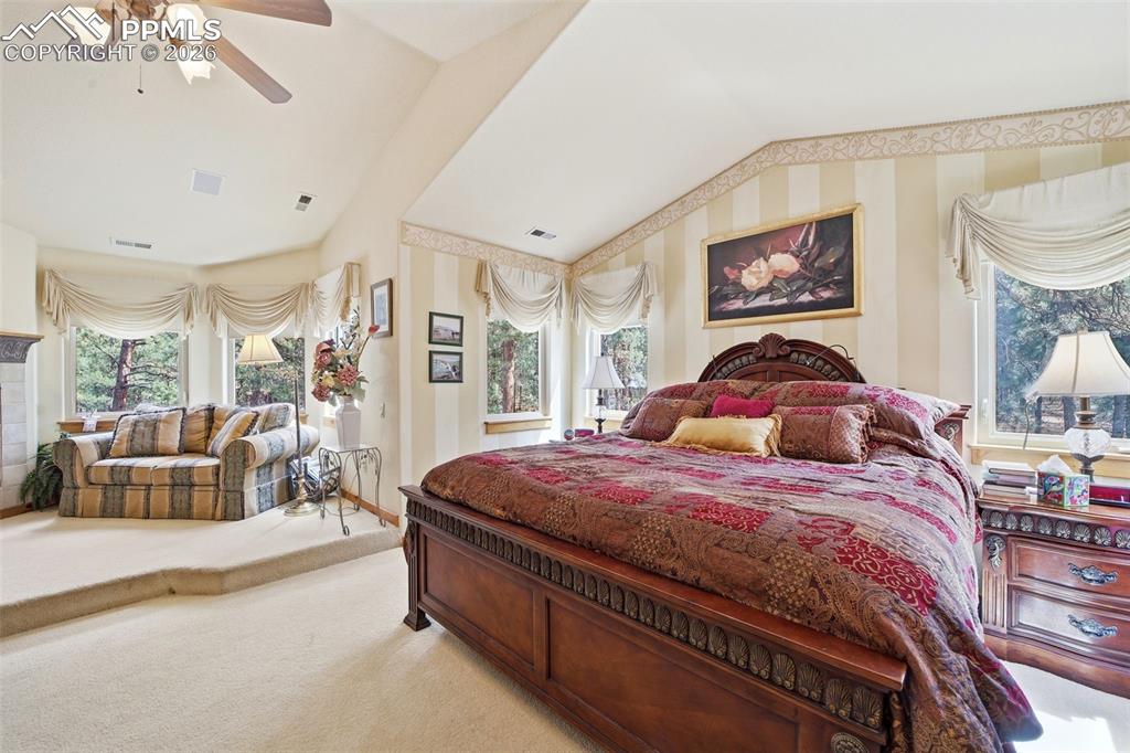 Image 39 of 50: Bedroom featuring vaulted ceiling, and ceiling fan entire suite with sittin
