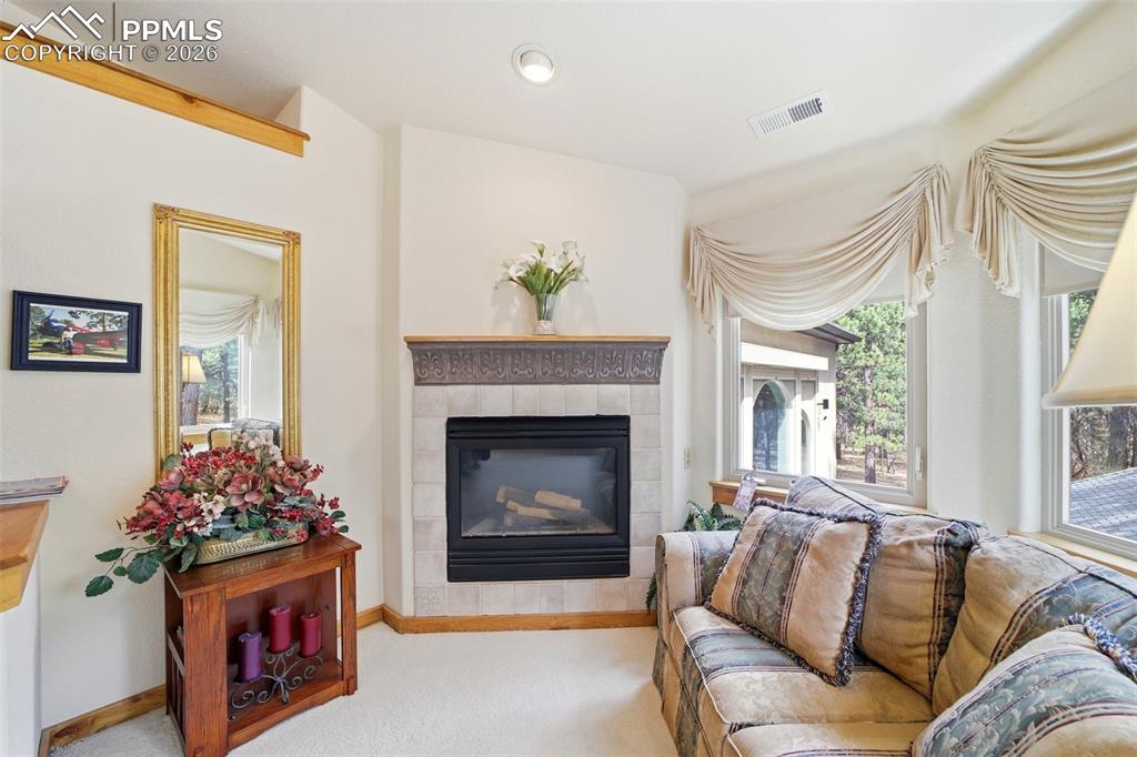 Image 40 of 50: Master bedroom retreat with its own sitting area and fireplace in the prima