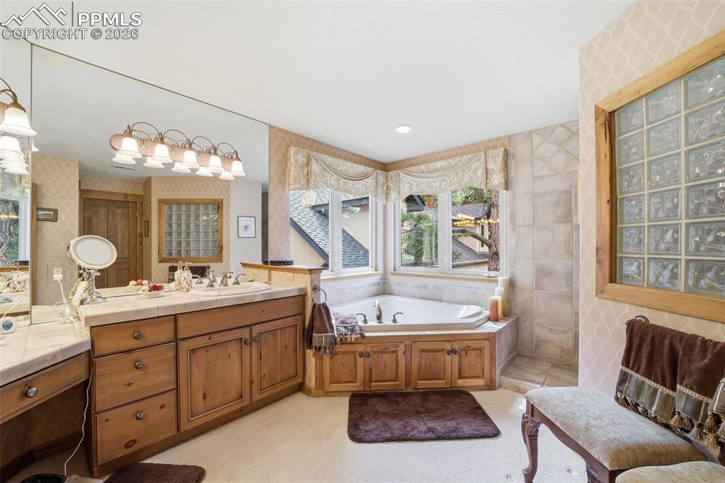 Image 45 of 50: Full bath with separate tub, separate shower, vanity and sitting area