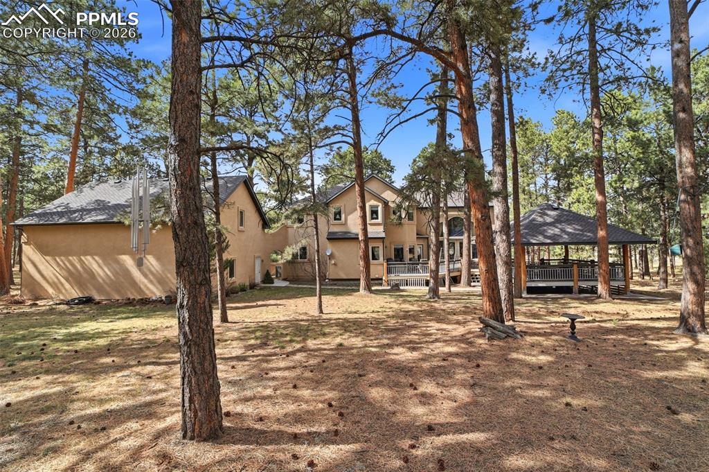 Image 7 of 50: Back of house with trees and privacy