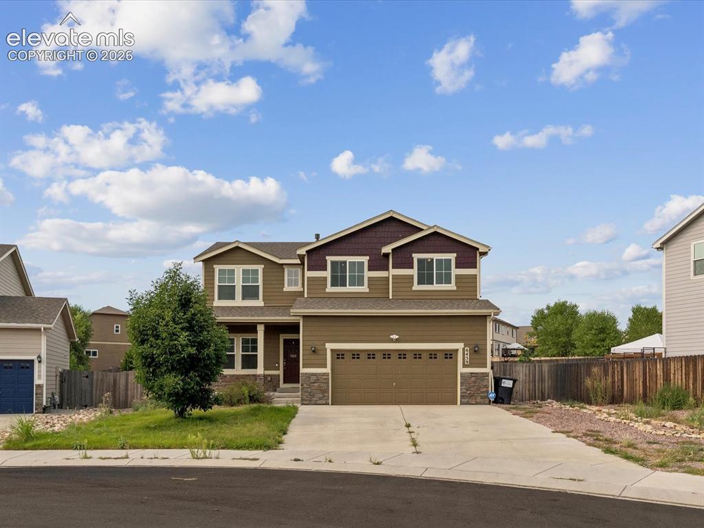 Image 1 of 23: Two-story home with a two-car garage and a stone facade accent