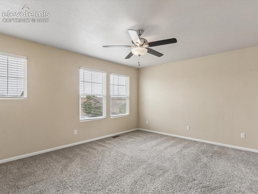 Image 15 of 23: Spacious room featuring neutral wall tones and a textured ceiling