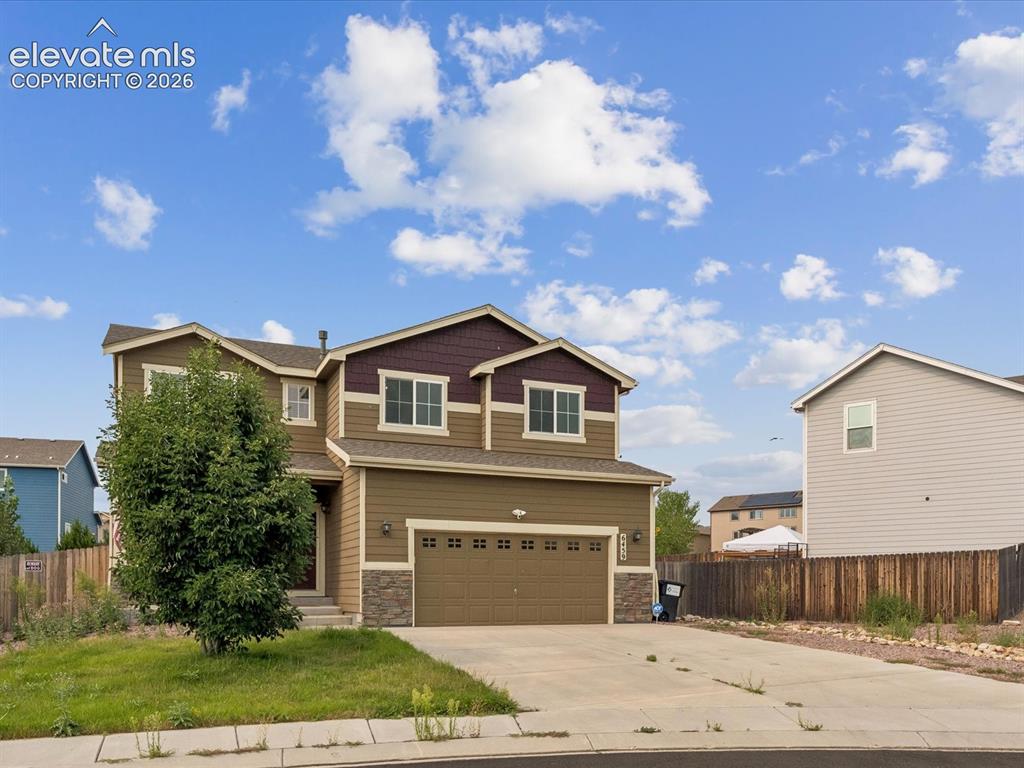 Image 2 of 23: Two-story residence featuring a multi-toned exterior with siding and stone