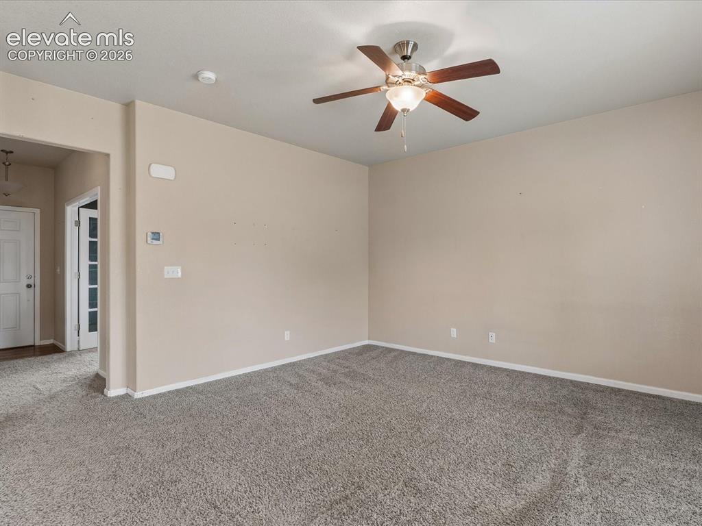 Image 7 of 23: Spacious room featuring neutral carpeting and wall tones